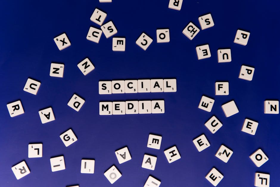 Scrabble tiles spelling 'Social Media' on a blue background, ideal for digital marketing themes
